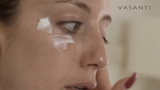 Closeup shot of a woman applying Vasanti Eye Wonder Triple Action Peptide Eye Cream under her eyes.